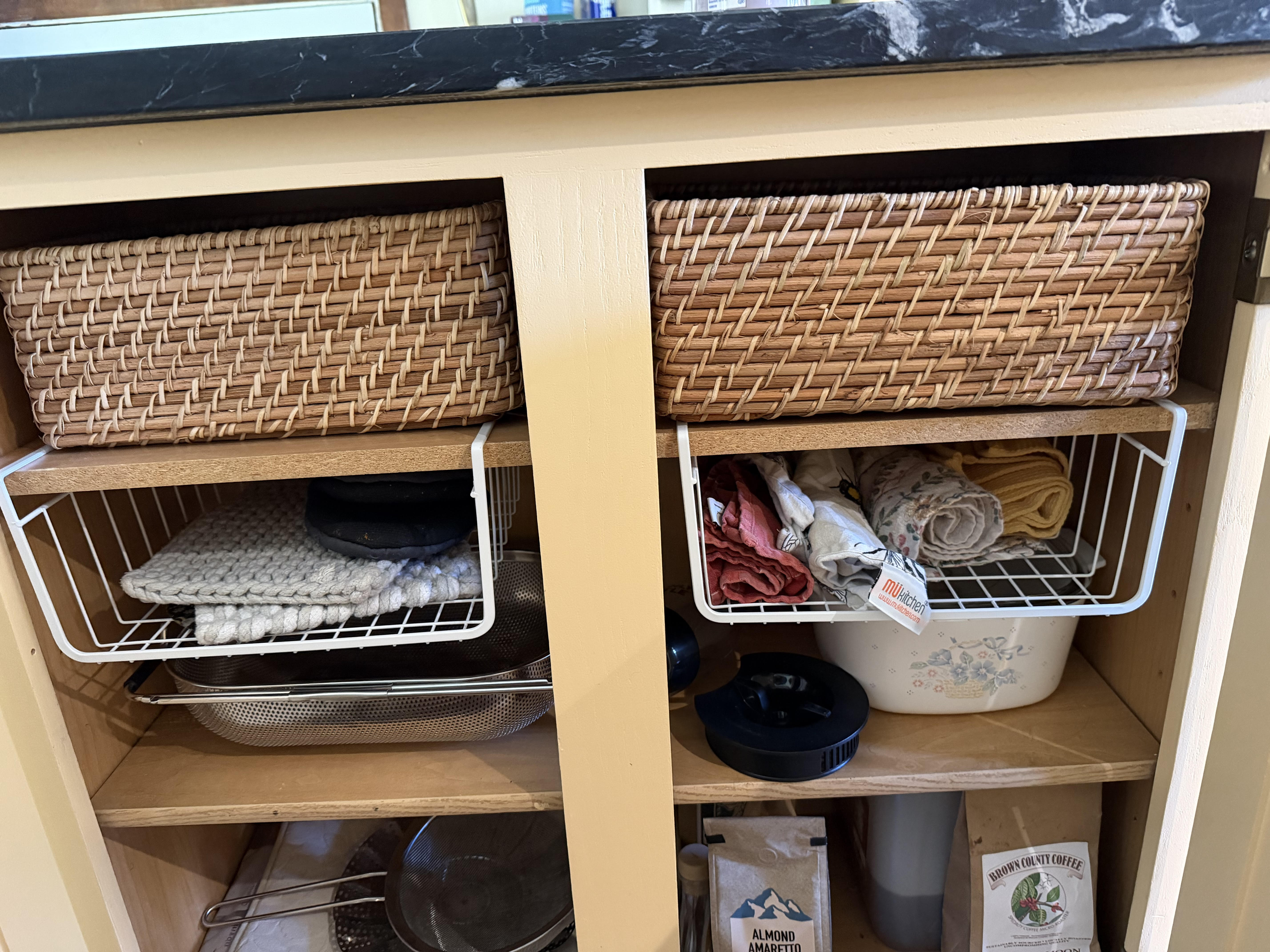 My cubbies hold towels and oven mitts in the empty space above the casserole and strainer